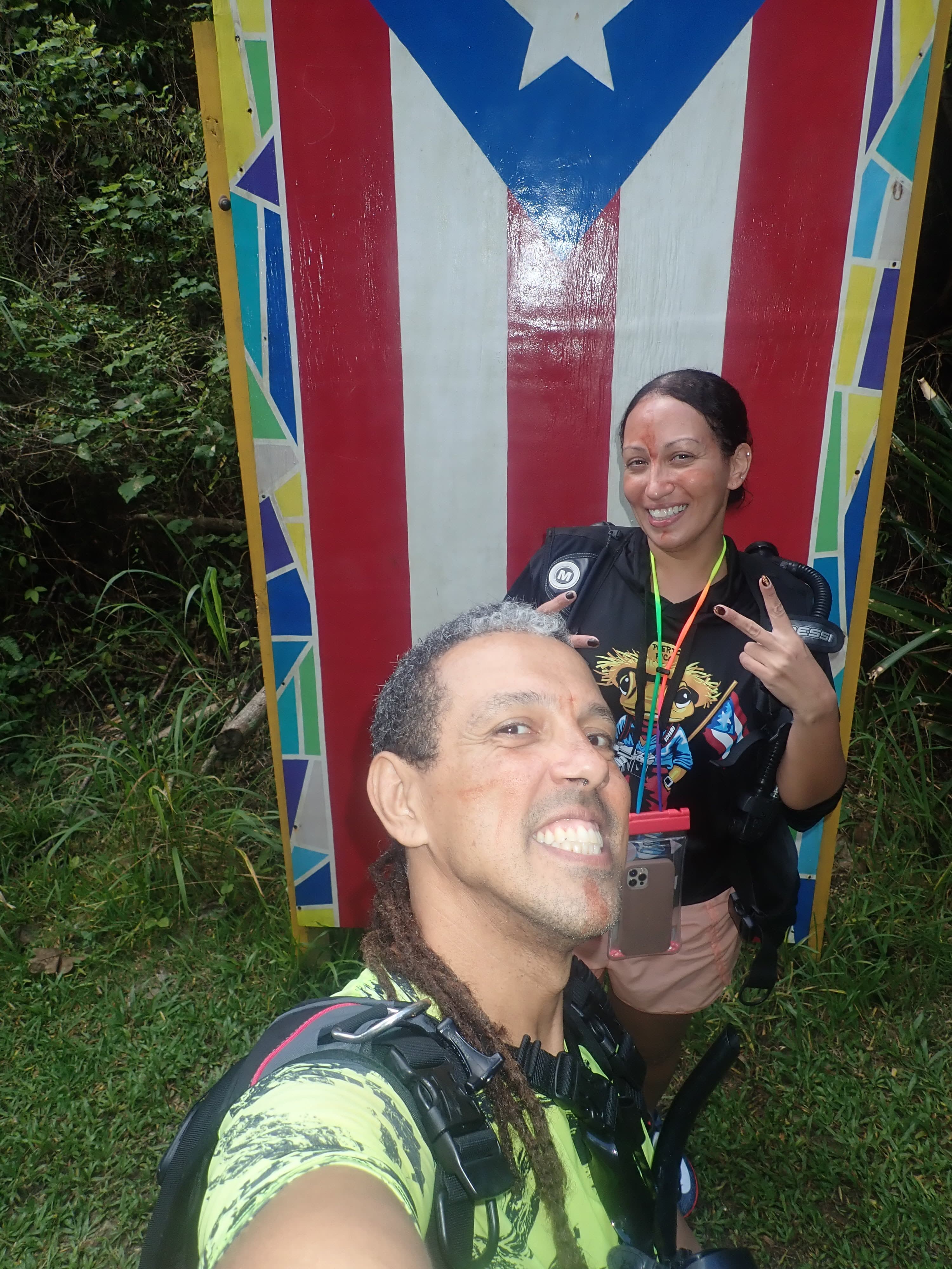Jesús and a guest at the Charco Azul Vega Baja sign