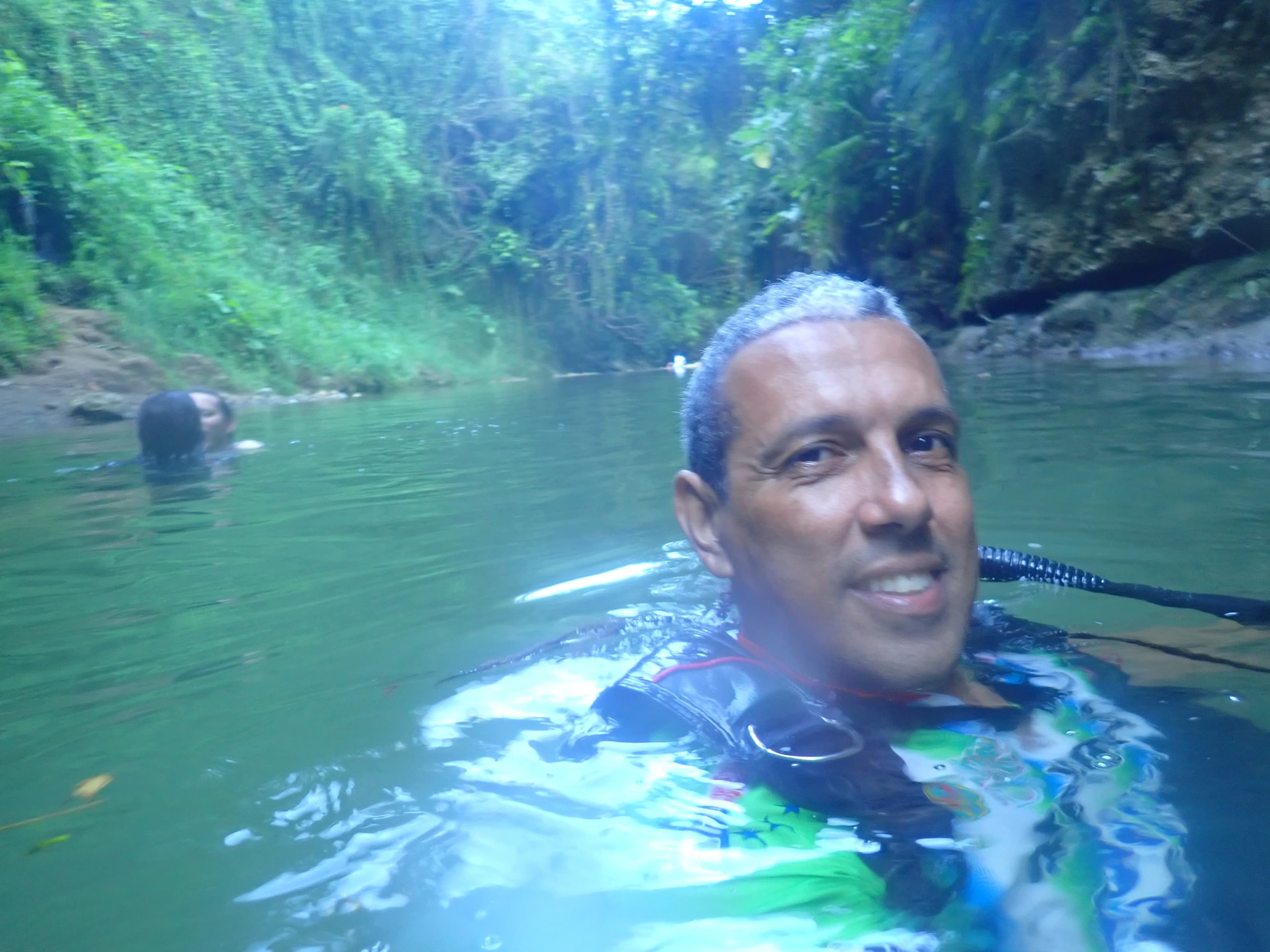 Jesús swimming in a jungle river