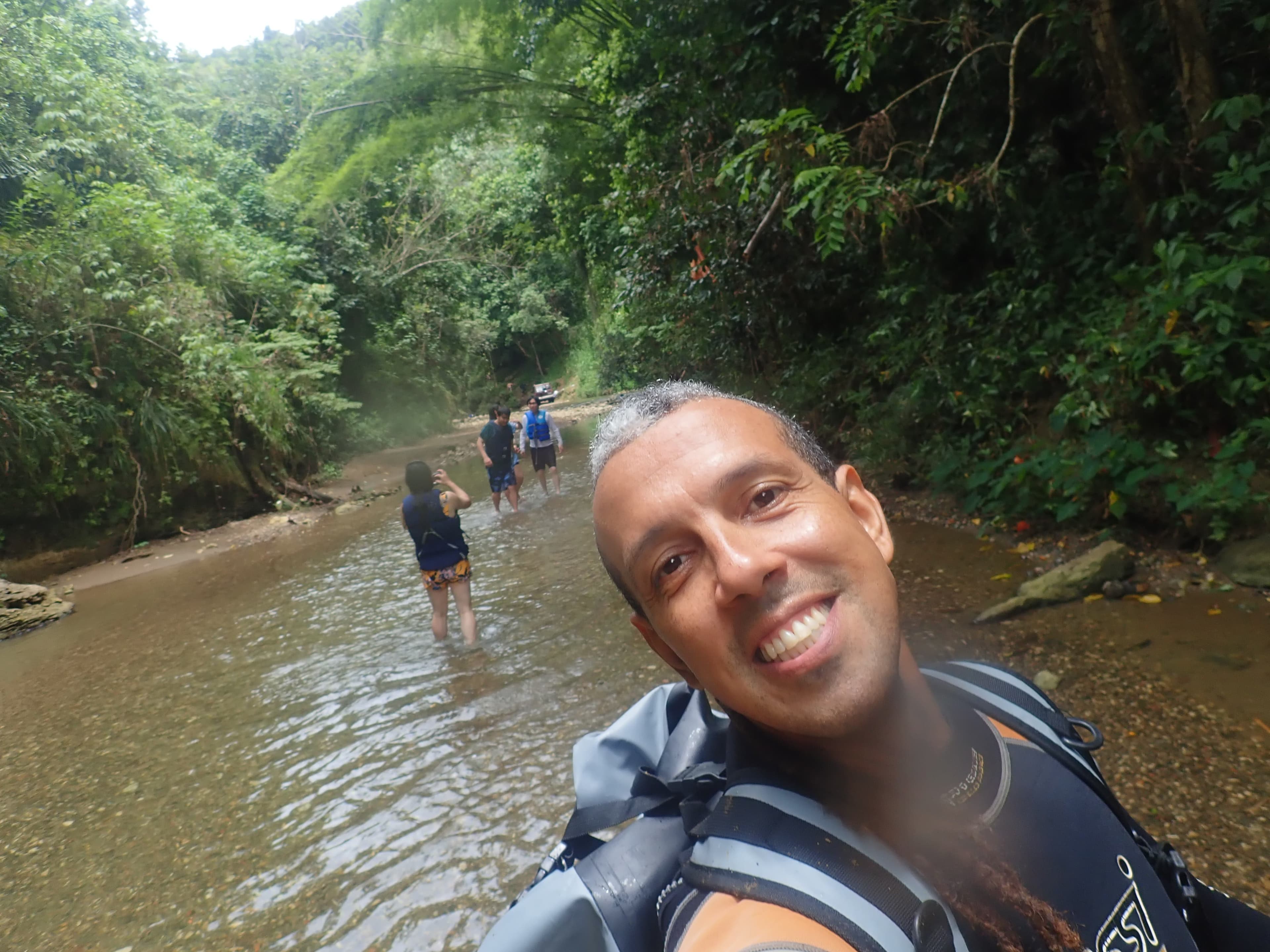 Jesús leading a river hike through the forest