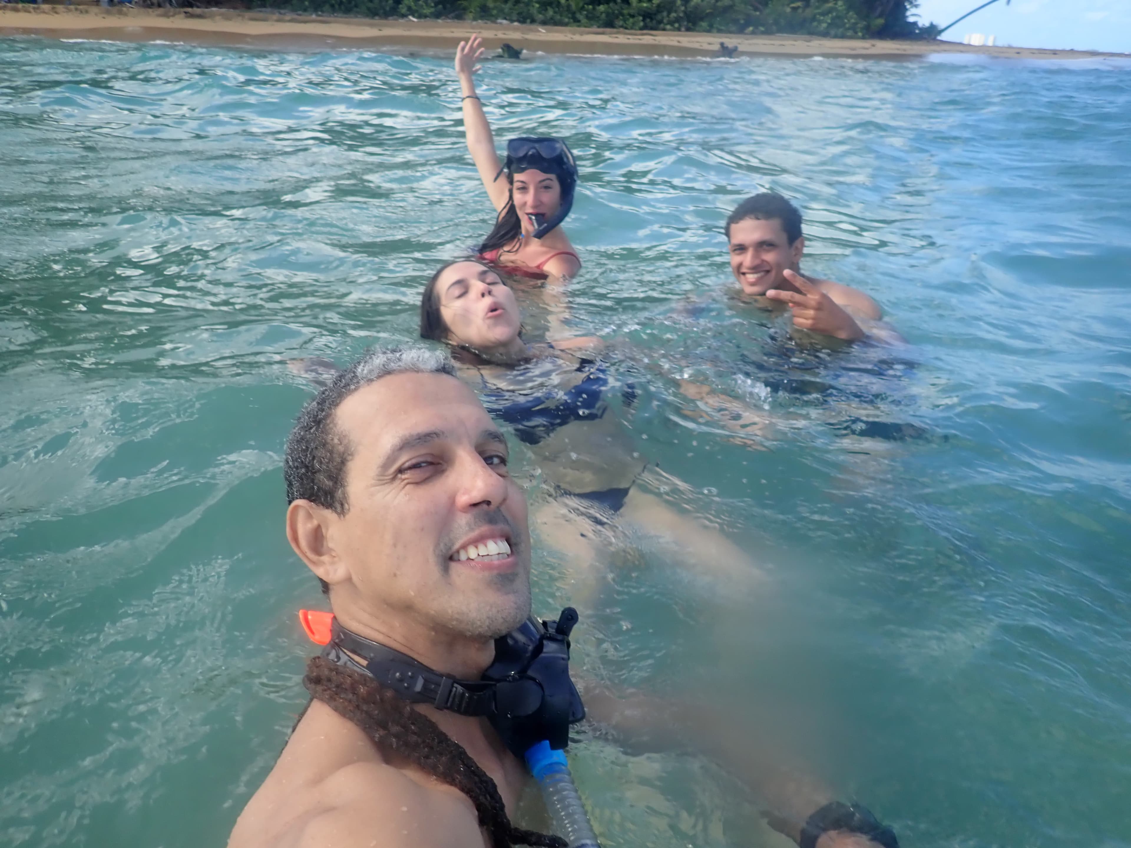 Jesús with a snorkel group in turquoise water